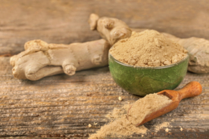 An image of ginger root and powder on a table