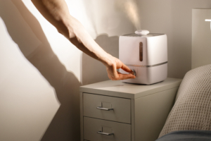 An image of a hand adjusting the steam on a humidifier