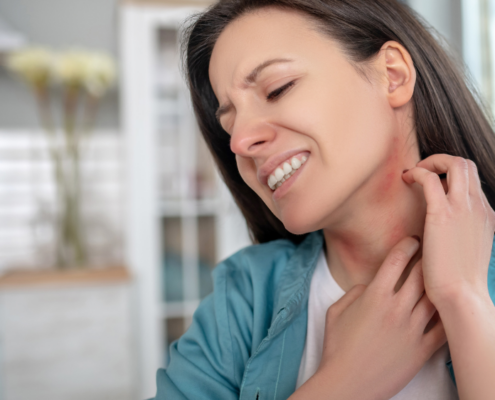 a woman not understanding throat irritants scratching her throat
