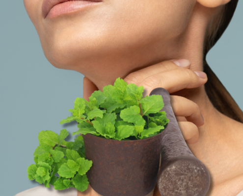 image for is peppermint good for sore throat post with lady holding her throat and peppermint plant