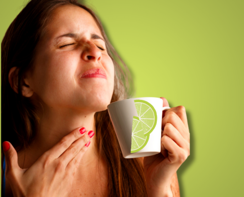 An image of a woman with tightness in throat drinking a cup of tea.