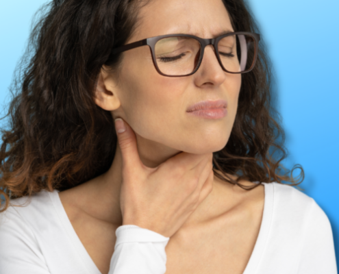 An image of a woman holding her sore throat